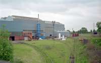 The Meadow Works of Sheffield Forgemasters (formerly RB Tennents) seen from the north in 1998. By this date the works' railway was isolated from the network. A sentinel locomotive can be seen peeping out the building to the left. The works closed in 2003.<br><br>This was the point of divergence between the M&K line to Palacecraig (left) and the later NB line to Hamilton via Bellshill (right).<br><br>[Ewan Crawford //1998]