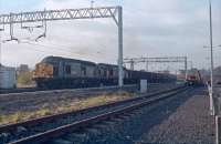 37323 'Clydesdale' and 37310 'British Steel Ravenscraig' head an ore train from Hunterston to Ravenscraig. Greenlaw goods yard is reduced to a single tamper siding and is just east of Paisley Gilmour Street station.<br><br>[Ewan Crawford //1988]