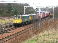 Freightliner locomotives 86610+86612 on the Coatbridge - Basford Hall containers approaching Carstairs on 8 March 2007. The train has just overtaken an EWS class 66 standing at a red light with a coal train bound for Drax power station. This train has originated from the nearby Ravenstruther loading terminal [see image 5590]. <br><br>[John Furnevel 08/03/2007]