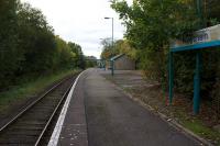 At the height of the popularity of Butlins Holiday Camp, Penychain had two 10 coach bidirectional platforms. The up platform survives in use and the down platform is now hidden by vegetation (left).<br><br>[Colin McDonald 14/10/2015]