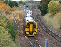 The 1016 service to Waverley (0928 ex-Tweedbank) pulls away from a leafy Brunstane station on 21 October 2015.<br><br>[John Furnevel 21/10/2015]