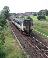 Just east of Annan station 156435 takes to the single track as it heads for Carlisle. By modern (slightly peculiar) naming standards the train would be passing 'Annan Junction'. Behind the camera was Solway Junction, the point of divergence between the lines to Carlisle and the Solway Viaduct. The railway has since been re-doubled.<br><br>[Ewan Crawford //1998]