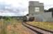 Freightliner Heavy Haul services from Oxwellmains to Aberdeen and Inverness now convey – thanks to award of Freight Facilities Grant – bogie vans of bagged cement which formerly moved by road. Both hopper wagons and vans can be seen in this shot of the Lafarge cement terminal deep in Millburn Yard, Inverness on 28th August 2015.<br><br>[David Spaven 28/08/2015]