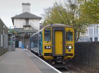 153353 stands at Cardiff Bay with the 12 minute interval shuttle to Queen Street on 18 October. Beyond is the former Taff Vale Railway's Cardiff Dock, later Bute Road station building.<br><br>[Bill Roberton 18/10/2015]