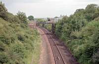 The bridge, seen here, which formerly carried the Solway Junction Railway over the G&SWR later bore the effluent pipeline from Chapelcross. Shawhill station was not far to the north (left) and a west to south curve connected the G&SWR with the SJR. The G&SWR line has since been re-doubled. View looks east.<br><br>[Ewan Crawford //1998]