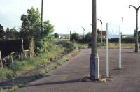 Looking along the disused east to south platform of the former triangular station at Forres in 1979. This platform was once used by trains to Aviemore via Dava Moor and closed to passenger traffic in 1965. The disused level crossing gate in the background stands alongside Tytler Street. [Ref query 5617] [See image 28610]<br><br>[Ian Dinmore //1979]