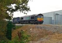 A 'just-in-time' picture. On the last Friday before the clocks went back, 66424 is leading the 18.39 departure from Daventry to Coatbridge FLT into the DIRFT yard on 23rd October 2015. This image was captured at 1734, giving the locomotive ample time to run around [see image 52864]. The train has just crossed the recently built bridge over the A428.<br><br>[Ken Strachan 23/10/2015]