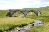 A September 2005 view of the bridge that carried the Leadhills and Wanlockhead line over the Elvan Water less than a mile after leaving the WCML near Elvanfoot station. More than a hint of 'Concrete Bob' about the structure, with the most notable bridge on the line, further west at Rispin Cleugh, definitely attributable to the man himself [see image 6453].<br><br>[John Furnevel 12/09/2005]