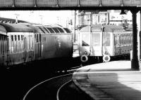 Looking out from the buffer stops along bay platforms 2 & 3 at Dundee on 25 September 1981, with some non-standard arrangements in place. On the left 47119 is standing in for the usual type 2 locomotive on a train to Glasgow Queen Street, while on the right railcar SC55007 has been substituted for the leading unit of a class 101 DMU on a service from Edinburgh Waverley. The upper section of Dundee West signal box can be seen in the background.   <br><br>[John Furnevel 25/09/1981]