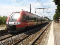 View north at Argeles Sur Mer station as the long distance service from Cerbere to Avignon, consisting of a 4 coach 27500 class EMU with driving coach 27865 at the rear, stands in the station with the 13.50 departure on 5th August 2015.<br><br>[David Pesterfield 05/08/2015]