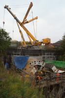'Fillie' the tunnel boring machine has completed its mission and now rests outside the northern portal of the Farnworth tunnel on 31 October 2015. Engineers have started the dismantling process with the large crane behind lifting sections out of the cutting. Access to take this photo was by kind invitation of the family who have been neighbours of the worksite for the last 6 months.<br><br>[John McIntyre 31/10/2015]