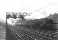 On a gloomy evening in July 1963 Stanier Pacific 46242 <I>City of Glasgow</I> approaches Eglinton Street with a 15 coach London train.   <br><br>[John Robin 12/07/1963]