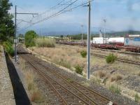 Looking west by Le Boulou east side yard along the branch line from Elne that continues to Ceret, albeit abandoned beyond the small yard at St-Jean-Pla-de-Cort some 4Km away. The line is electrified for a further 1.5Km to the end of the head shunt for the west side intermodal yard located on the far side of the Le Boulou A6 E15 autoroute payage point sited at the far end of the sidings to the right of view. [See image 52703] for view in opposite direction.  <br><br>[David Pesterfield 05/08/2015]