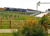 Here's one I prepared earlier [see image 53055]. The DRS service for Sainsbury's is about 12 hours away from its scheduled arrival at Coatbridge FLT. The foreground is surprisingly pleasant as the environs of warehouses go; a small gap in the vegetation makes it hard to avoid getting a lamppost in front of the locomotive. This view will, however, be impossible in a few years' time, when those trees have grown up a bit.<br><br>[Ken Strachan 23/10/2015]