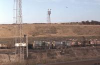 <I>Master and Slave</I> Hump Shunter 13002 going about its business among various loose coupled wagons in Tinsley Marshalling Yard in November 1979. The former D4502 was the first of the class to be withdrawn in 1983 and was later cut up at Swindon Works. Classmates 13001 and 13003 lasted until closure of the yard in 1985 but were also scrapped. <br><br>[Mark Bartlett 26/11/1979]