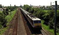 A Class 90 in Inter City livery heads north from Preston in May 1993, passing Oxheys Loop.<br><br>[John McIntyre /05/1993]