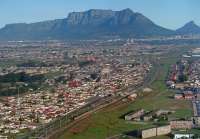 Lavistown on the Central Line of the Cape Metro with Cape Town and Table Mountain in the backdrop of this west facing 2002 view.<br><br>[Ewan Crawford //2002]