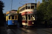 In late autumn morning sunshine the Beamish tramway prepares for a busy Sunday. Both vehicles advertise a Department Store well known to generations of North East shoppers.<br><br>[Brian Taylor 01/11/2015]