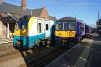 ATW 175102 heading for Manchester and Northern Electrics 319361 heading for Liverpool call at Newton-le-Willows on 9 October 2015.<br><br>[John McIntyre 09/10/2015]