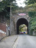 Looking along South End Gardens towards Stakesby Vale thro the  extant penultimate overbridge crossed by services running from Scarborough on the approach to Whitby West Cliff station. The next bridge crossing Spring Vale was removed some 20 years ago. The trackbed south from here is now identified as The Cinder Track Scarborough-Whitby by a BR NE Region style totem mounted above the arch with the legend Where Will It Take You curving around the arch. <br><br>[David Pesterfield 23/10/2015]