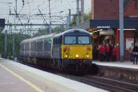 Bringing back memories of 40 years ago as 87002 some Mk2 and 3 coaches head south on the WCML at Wigan North Western on 9 October 2015. Some of the passengers waiting for a late running Pendolino may have thought that their luck was in but this was a sleeper ecs move from Polmadie to Wembley. A problem with one of the previous nights services resulted in this train making its way south in a hurry, quite late in the day considering it was returning north later the same evening.<br><br>[John McIntyre 09/10/2015]