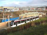 Work well underway on Edinburgh Gateway interchange on 11 November 2015, with an Airport bound tram passing through on the lower level and a 158 for Waverley about to run through the station in the left background. Off picture to the right work is also underway on the pedestrian subway under the A8 which will give direct access to the Gyle shopping centre.<br><br>[John Furnevel 11/11/2015]