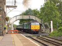 A Great Yarmouth - Norwich service formed by locomotive hauled stock operating in T&T formation pulls away from the Brundall stop on 9 June 2015. DRS 47813 is the leading locomotive with 47818 at the rear. These operations have become necessary due to a shortage of serviceable DMUs.  <br><br>[Ian Dinmore 09/06/2015]