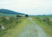 Milepost 94, seen here on the left, lies immediately north of the Dulnain Bridge on the Highland line to Forres. This view looks north in 1982, along the trackbed that is now being relaid towards the destination of Grantown-on-Spey just over two miles away.<br>
<br><br>[Peter Todd /08/1982]