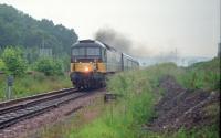 An Aberdeen bound 47 hauled train approaches Raigmore level crossing east of Millburn Junction in 1990. The remains of the 'Burma Road' are to the right.<br><br>[Ewan Crawford //1990]