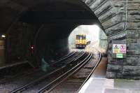 View south through the short tunnel, from the Liverpool platform at Green Lane, as 507010 climbs the 1:35 gradient to take it up to the level of the old Chester and Birkenhead main line, which is above the wall on the left of the EMU. Next stop for the train is Rock Ferry on the way to Hooton and Chester.  <br><br>[Mark Bartlett 16/11/2015]