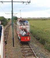 Two half scale replica tramcars meet at a passing loop just north of the Seaton Tramway depot. The loop is one of several on the three mile line, allowing a frequent service at peak times. Tram No.2 is seen heading north for Colyton along the old railway formation.   <br><br>[Mark Bartlett 01/08/2015]