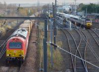 Busy scene at Craigentinny Depot. 67013 passes with the Oxwellmains - Powderhall empty 'bins'. The New Measurement Train and a CrossCountry HST are in the yard. Beyond the latter can just be seen 73966, heavily rebuilt for use on the Caledonian Sleeper.<br><br>[Bill Roberton 24/11/2015]