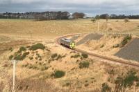 The ScotRail 1159 Tweedbank - Edinburgh Waverley service rounding the curve at Falahill on 26 November 2015, followed by a shower of rain.<br><br>[John Furnevel 26/11/2015]