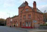 A deceptive station building. Although a railway line runs directly behind Green Lane station (see bridge on left of picture) those are the now closed tracks of the Chester to Birkenhead Woodside line. Green Lane's platforms are underground and accessed by lift or stairs [See image 53282]. The station serves the ship building area of Birkenhead and, although not as busy as in its heyday, still has six trains an hour in each direction.<br><br>[Mark Bartlett 16/11/2015]