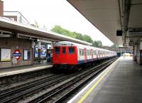 Metrpolitan 1960 'A stock' unit 5034 bringing up the rear of an  mid-morning Uxbridge - Aldgate train, calling at Harrow-on-the-Hill platform 5 on 23 July 2007. [Note: This unit, in conjunction with unit 5063, operated the last scheduled Metropolitan Line services undertaken by the class on 26 September 2012 and carried a special headboard throughout the day reading <I>'A Stock'   1960-2012   Last Day in Service</I>.] <br><br>[John Furnevel 23/07/2007]