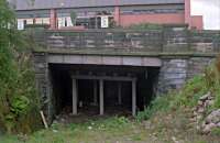 In 1988 the cutting between Maryhill Road and the Forth and Clyde Canal was filled in. The station site, seen beyond the bridge, was filled in for the Maryhill Shopping Centre which in turn has become a Tesco. Behind the camera the line continued east to Possil with a siding to the Maryhill Iron Works branching off to the north. This view is no longer possible with the ground level now raised to the height of the roadway.<br><br>[Ewan Crawford //1988]