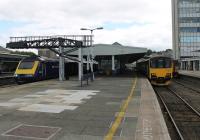 View from the west end of Plymouth station, with 43037 ready to depart for Penzance and 150131 in the bay on Gunnislake branch duties for the day. Over on the right, just visible behind the Sprinter, is a 153 unit probably acting as spare for the Cornish branches. <br><br>[Mark Bartlett 29/07/2015]