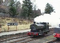 Barclay 0-4-0ST 'Clyde' racing (pounding) through Boat of Garten Station. Easter 1983.<br><br>[Peter Todd /04/1983]