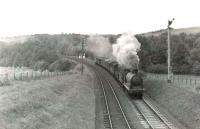 Ex-Caledonian 0-6-0 57633 heading north towards Ayr with the Girvan goods on 6 August 1960. The train is leaving 'Ben's Cut' in the Girvan Valley and is about to pass Kilkerran's down distant signal. [Ref query 4839] <br><br>[G H Robin collection by courtesy of the Mitchell Library, Glasgow 06/08/1960]