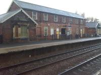 Looking north to the large down side station building at Pontefract Baghill which now has a more road based usage compared to its original purpose; with the far half now used as a DSA Driving Test Centre. The entrance tunnel to access the platforms can be seen at the centre of the main building, with the lighter coloured lower brickwork previously being below a full length canopy running between the wings at each end. Cast canopy support pillars are still in place.<br><br>[David Pesterfield 13/11/2015]