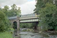 DMU crossing Kippenross Viaduct just south of Dunblane in 1990. The DMU is about to enter Kippenross Tunnel which is immediately to the right. This was an unnecessary tunnel which was required by the landowner to avoid despoiling of his land.<br><br>[Ewan Crawford //1990]