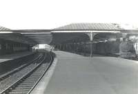 Looking south through Ardrossan Town station in the summer of 1959. On the right a train for Kilmarnock is waiting in the bay behind Hurlford shed's 2P 4-4-0 no 40644. In the left background the gates of Princes Street level crossing are closed to rail traffic, with part of Princes Street signal box visible just beyond. [See image 37014]<br><br>[G H Robin collection by courtesy of the Mitchell Library, Glasgow 06/07/1959]