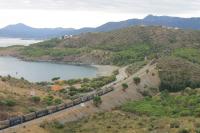 Two RENFE Class 269 electric locos double head a freight along the coast at Colera in Catalonia. This southbound freight was an unexpected bonus as I had just photographed a northbound passenger service [see image 52692] when it rumbled into view. The landscape of this part of the Costa Brava has some definite similarities to the west coast of Scotland. <br><br>[Mark Bartlett 22/09/2015]