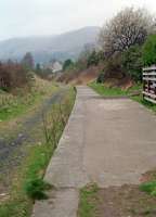 Dollar, looking to Alloa, in 1991. This shows the section of platform which was covered by a shelter [see image 27868]. The ballast was relatively intact at the time but trackbed has since been converted into a 'tarmaced' footpath.<br><br>[Ewan Crawford //1991]