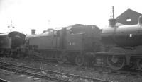 Stanier 3P 2-6-2T 40186 stands in a siding alongside Eastfield shed in late 1963. Withdrawn from Motherwell at the end of the previous year, the locomotive was one of a number temporarily stored here awaiting transfer to nearby Cowlairs Works for cutting up. This finally took place in December 1963.<br><br>[K A Gray //1963]