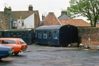 During the era of railway closures, the sequence of events was typically: Disappearance of DMUs, lifting of the track, structural decay of the buildings and ultimately demolition of the ruins. At Yarmouth South Town, the actual sequence was rather different: Withdrawal of services, track lifting, dereliction and demolition – to leave a DMU. This photo was taken on the site of the Yarmouth South Town terminus on 16th May 1981 after the station had been razed completely and shows one of the last railway relics to have been part of a Cravens DMU body that had been used as a store.<br><br>[Mark Dufton 16/05/1981]