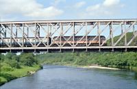 This Spey Viaduct is just east of Orton and is viewed from the B9103 equivalent in 1990. 'University of Dundee' crosses with an Aberdeen bound train. This is the 1906 rebuild of Joseph Mitchell's 1856 bridge (see Tatlow's 'Highland Miscellany' for a view of the bridge being rebuilt).<br><br>[Ewan Crawford //1990]