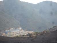 A quick grab shot into sun looking down onto Portbou transhipment yard. Taken on 7 August 2015 from the narrow winding mountain road between Portbou and Cerbere. The lengthy intermodal rake seen stabled is that propelled into the yard by SNCF Fret Bo-Bo Shunter 469203 [See image 53109]   <br><br>[David Pesterfield 07/08/2015]