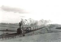 A returning excursion from Ayr to Carlisle on the climb to Tarbolton on 24 May 1962. The locomotive is 72009 <i>Clan Stewart</i>. [Ref query 52559] <br><br>[G H Robin collection by courtesy of the Mitchell Library, Glasgow 24/05/1962]