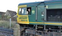 The driver of Freightliner 66515 gives a friendly wave as he reverses into the sidings at Barassie Junction on 19 November before running round. Longannet power station is due to close in March 2016, so this traffic will also cease.<br><br>[Ken Browne 19/11/2015]